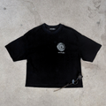 distressed black boxy tee with sun and moon design small on left chest with small brand word mark: ever & after layflat on concrete with rose 