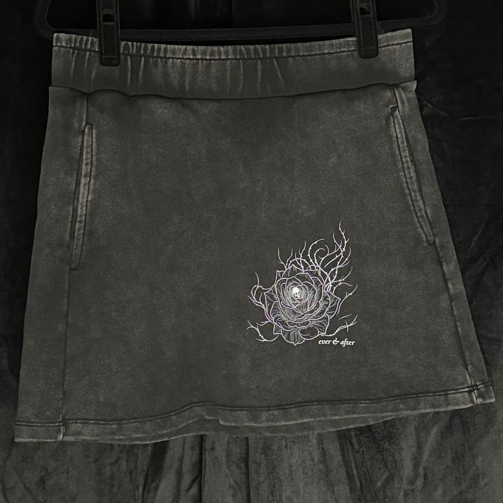 Black skirt with embroidered design on a dark background
