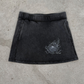 Black skirt with a design on a concrete surface