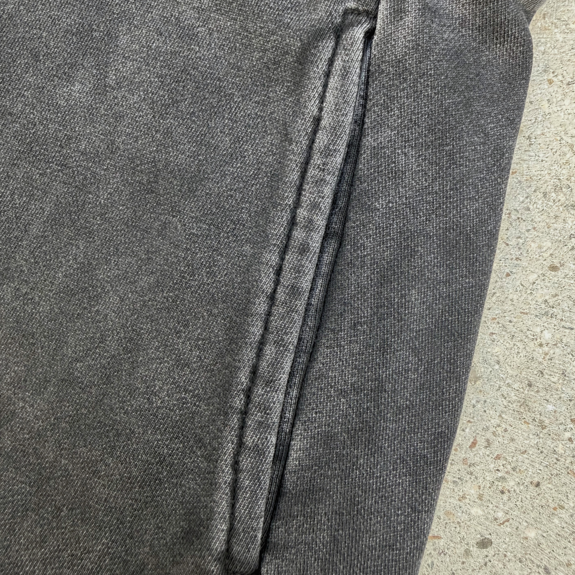 close up of mini-skirt, highlighting pocket on concrete surface