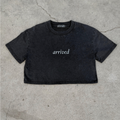 Black t-shirt with 'arrived' text on a concrete surface