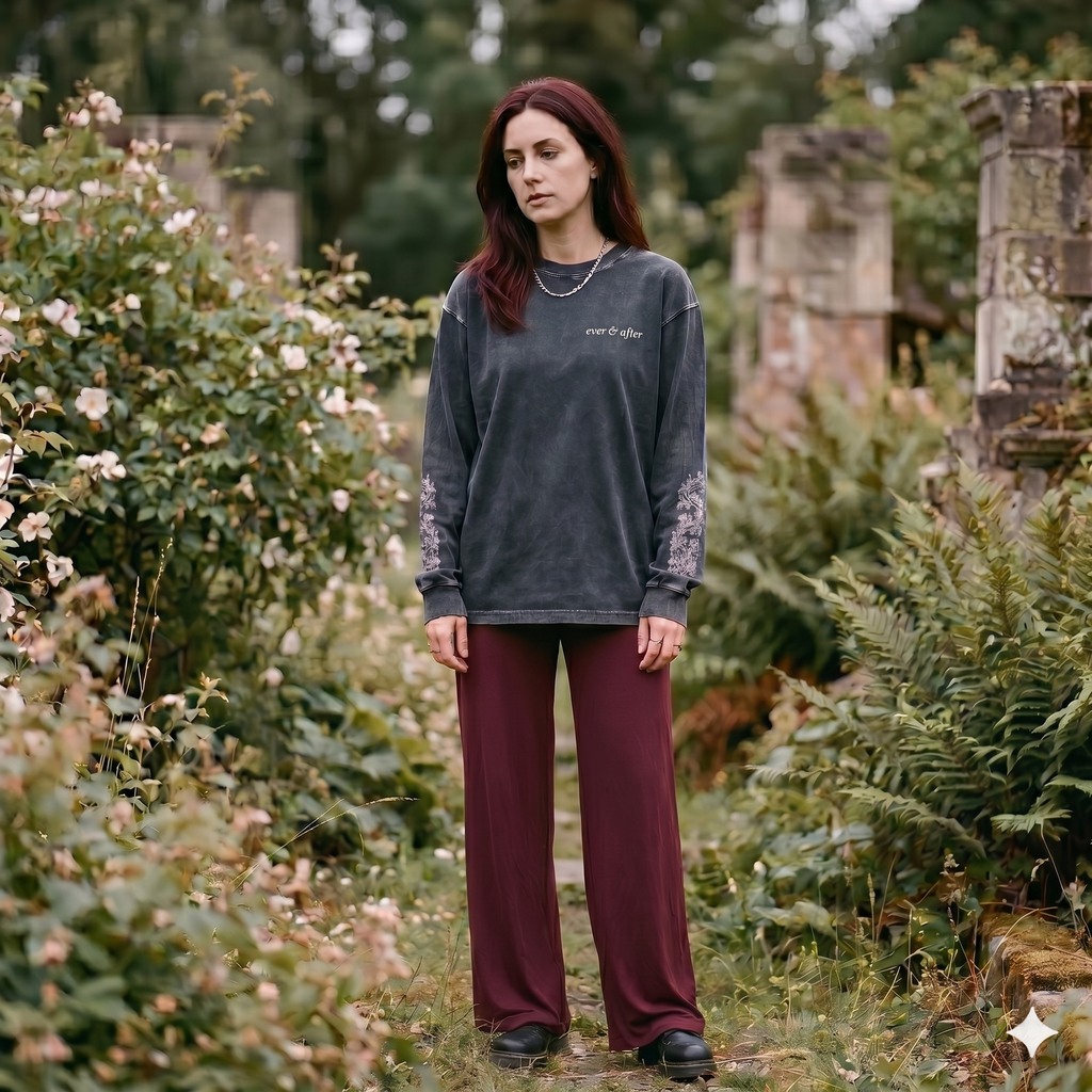 Woman standing in a garden with greenery and ruins in the background