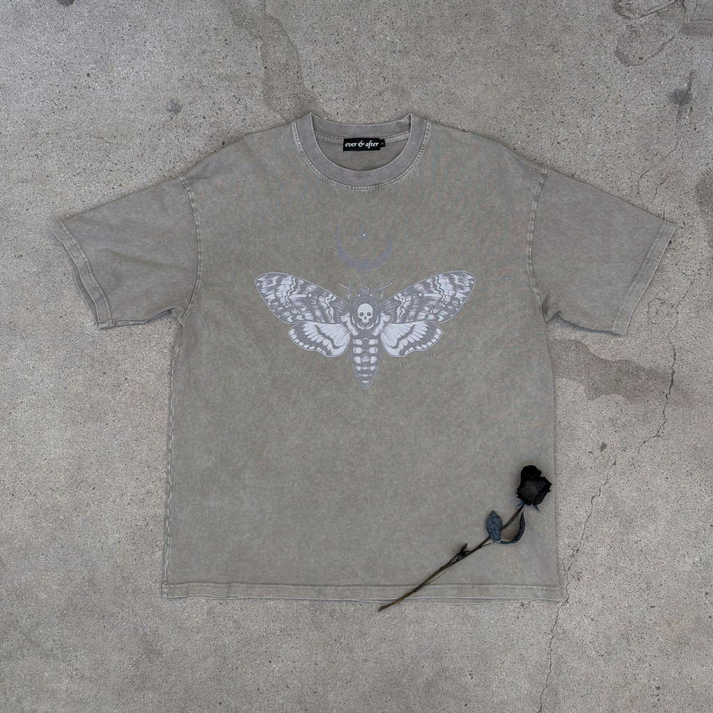 bone wash oversized moth tee lay flat on concrete with rose