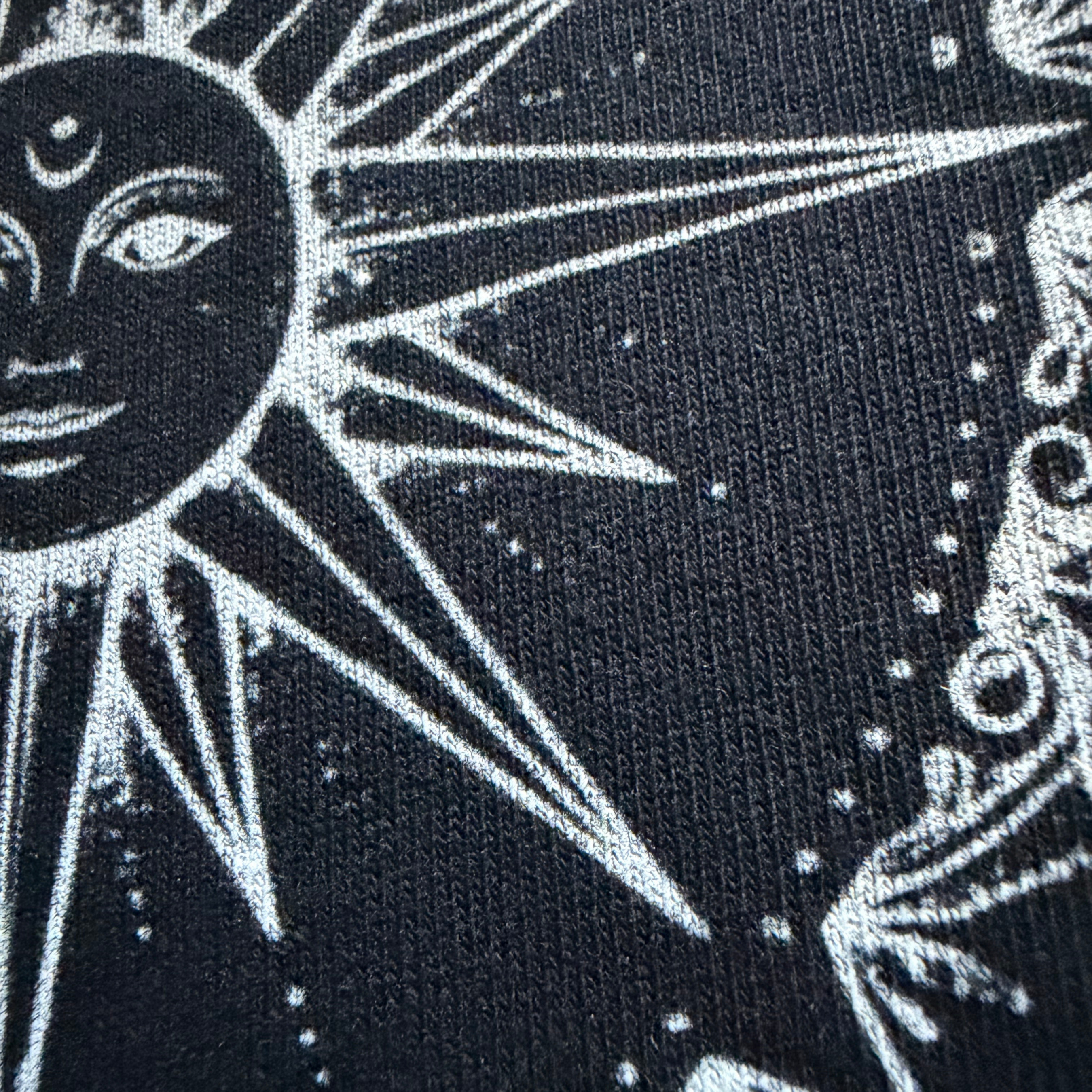 Black fabric with white sun and moon design