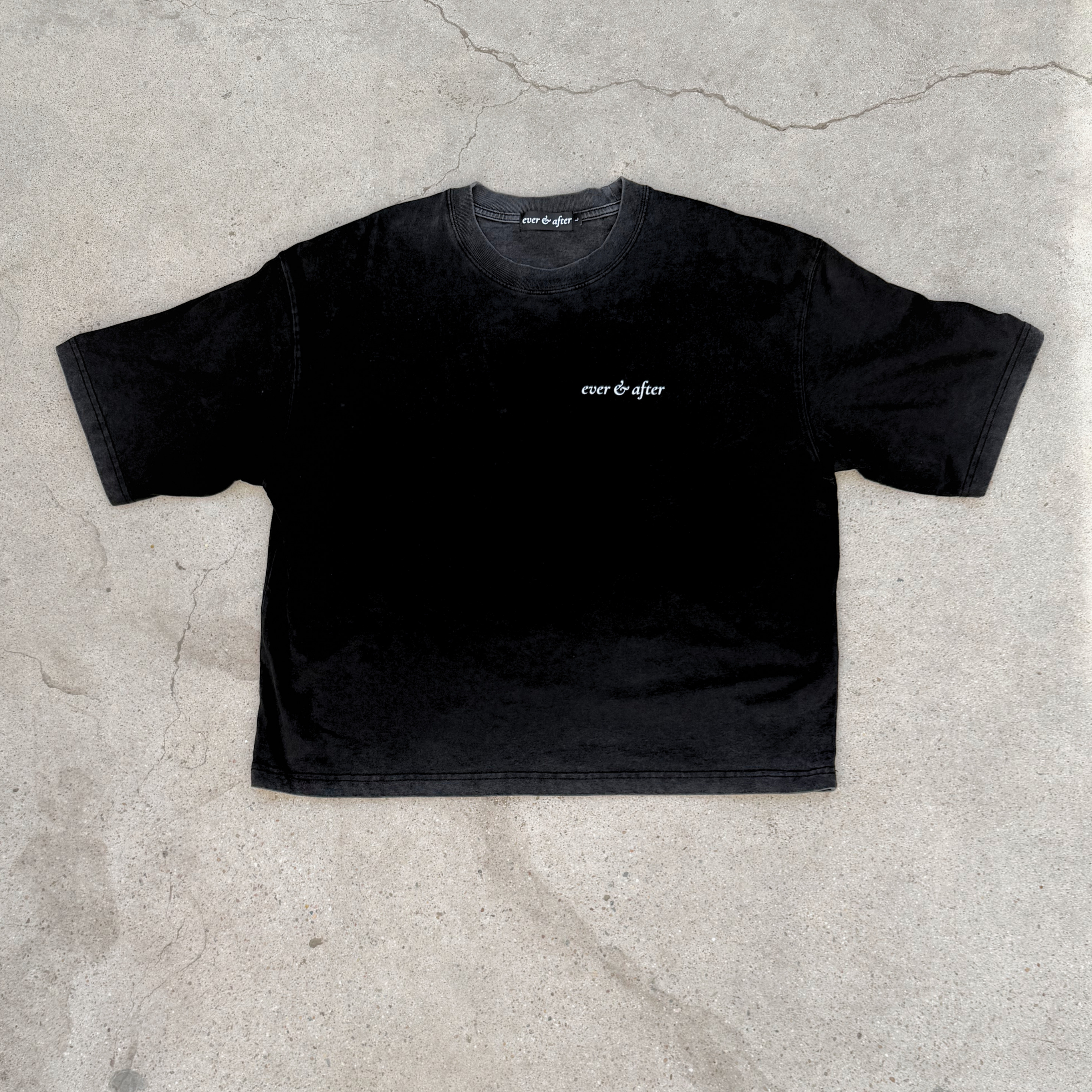 Black t-shirt with 'ever & after' logo on a concrete surface