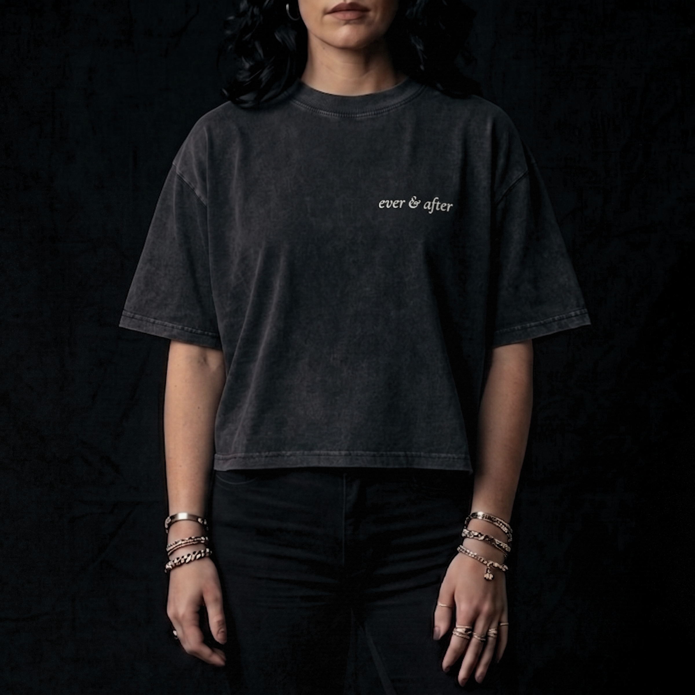 Person wearing a black t-shirt with 'ever & after' text on a dark background