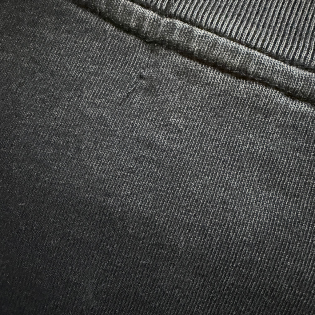 Close-up of dark gray fabric with a visible seam