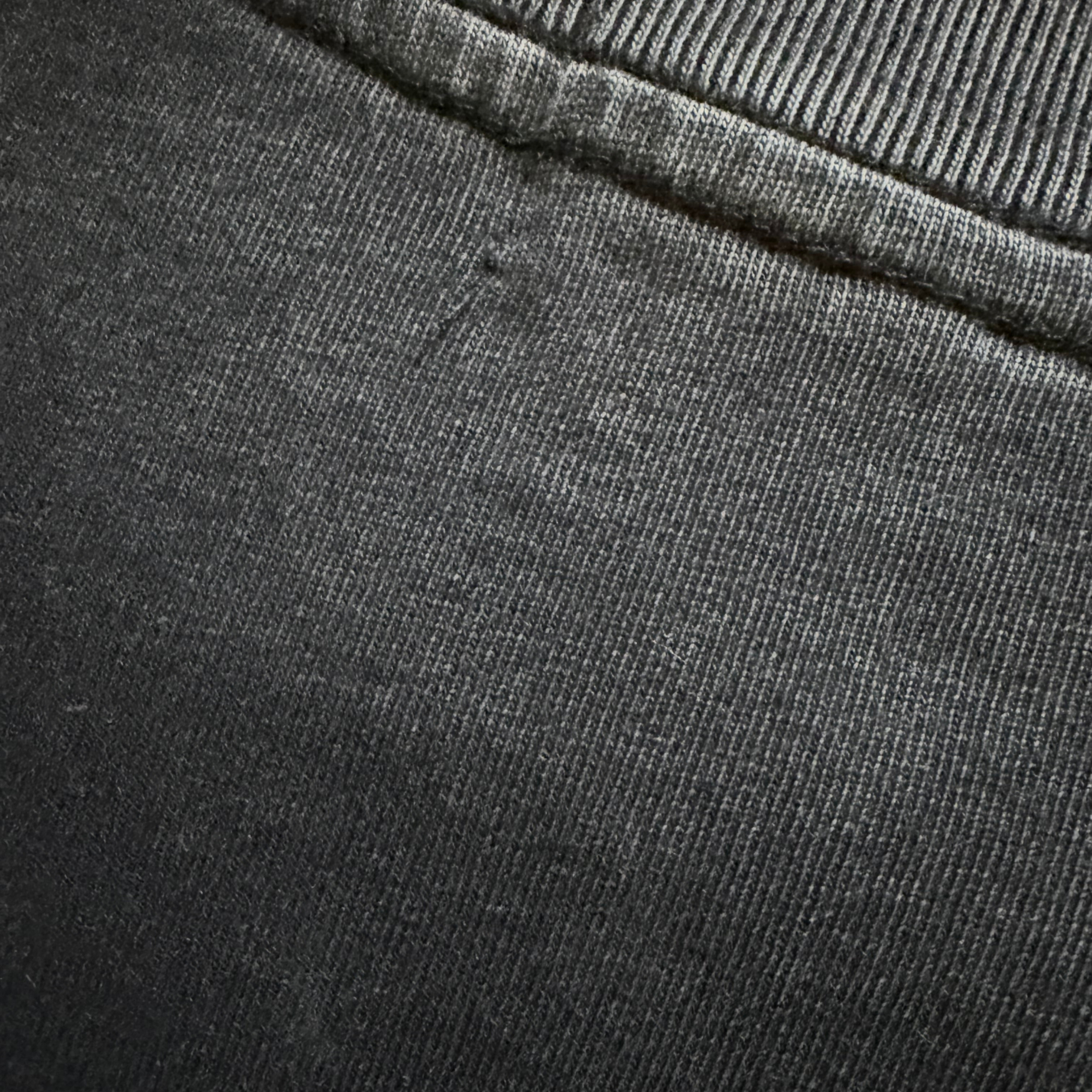 Close-up of dark gray fabric with a visible seam