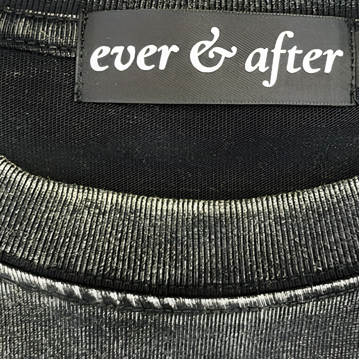 Close-up of a black fabric with 'ever & after' label.