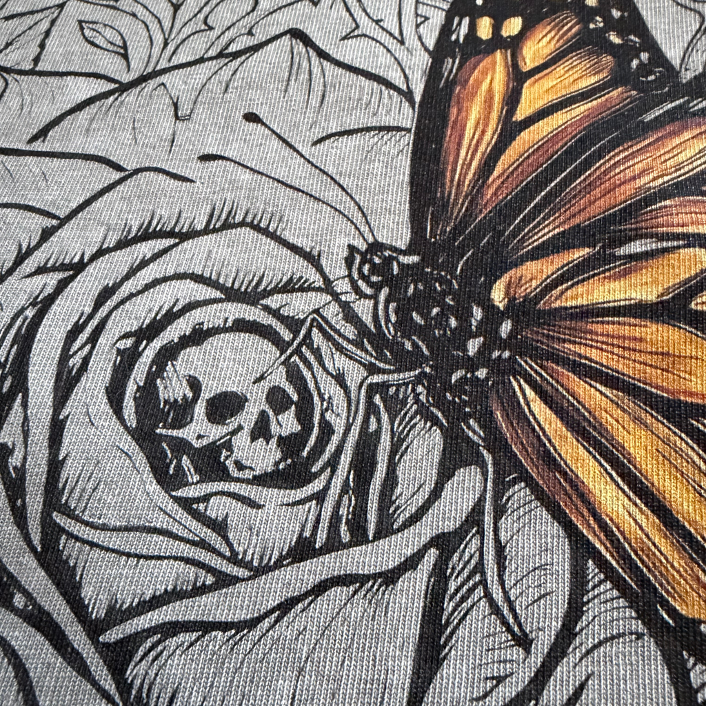 close up detail of rose and butterfly design