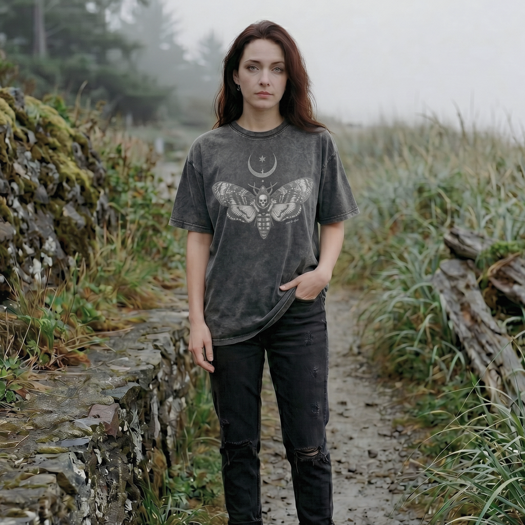 alt millennial woman wearing snow wash dark gray oversized tee with moth and moon design center on chest and brand word mark underneath