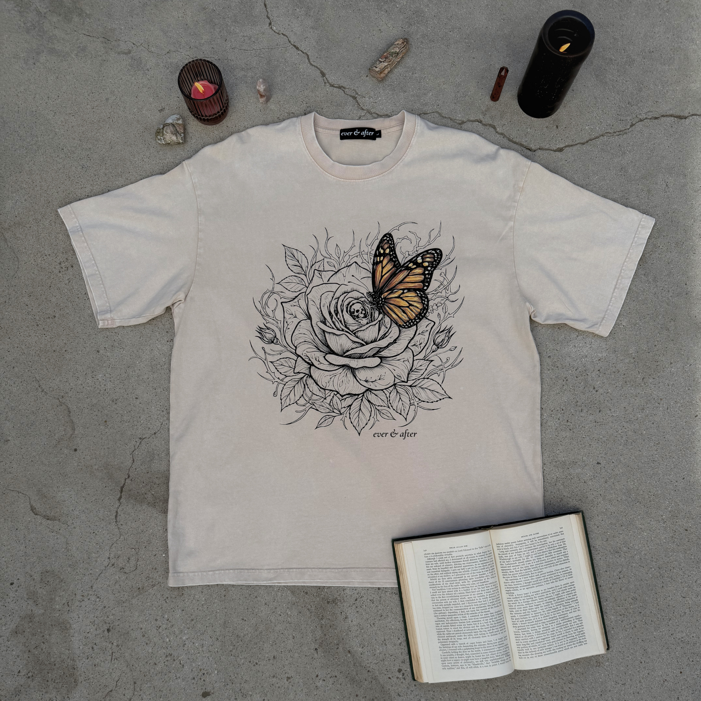 flaylat of light beige tee with rose and butterfly graphic design