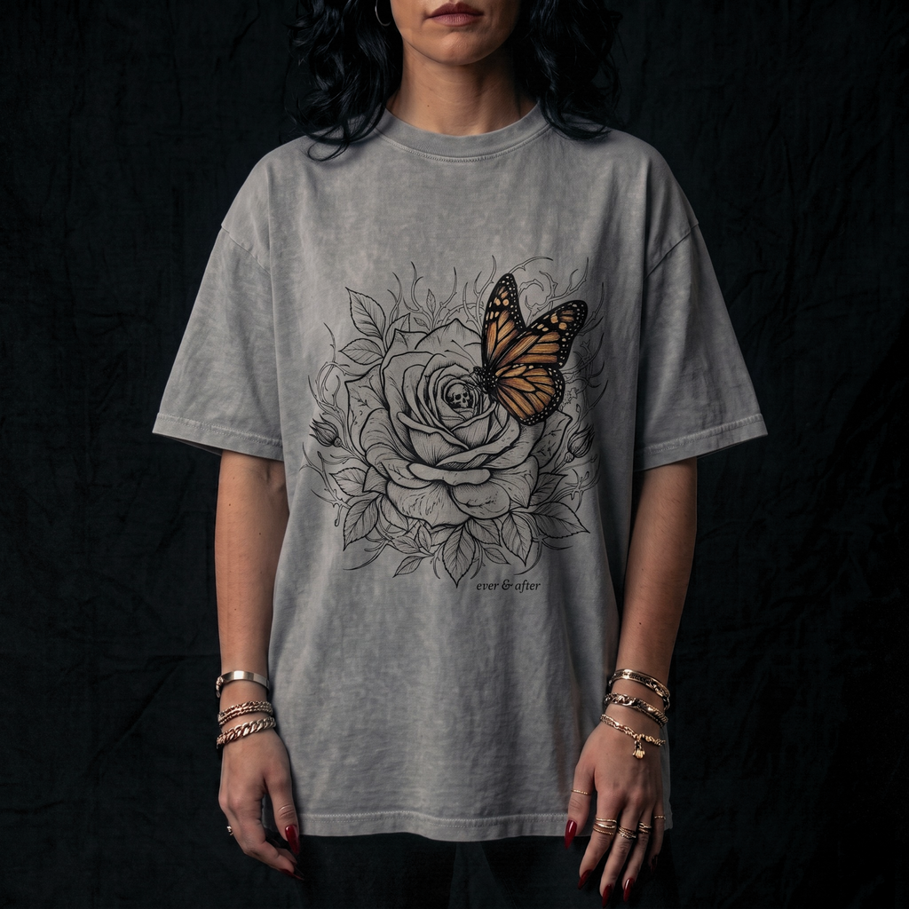 Person wearing a gray t-shirt with a butterfly and floral design on a black background