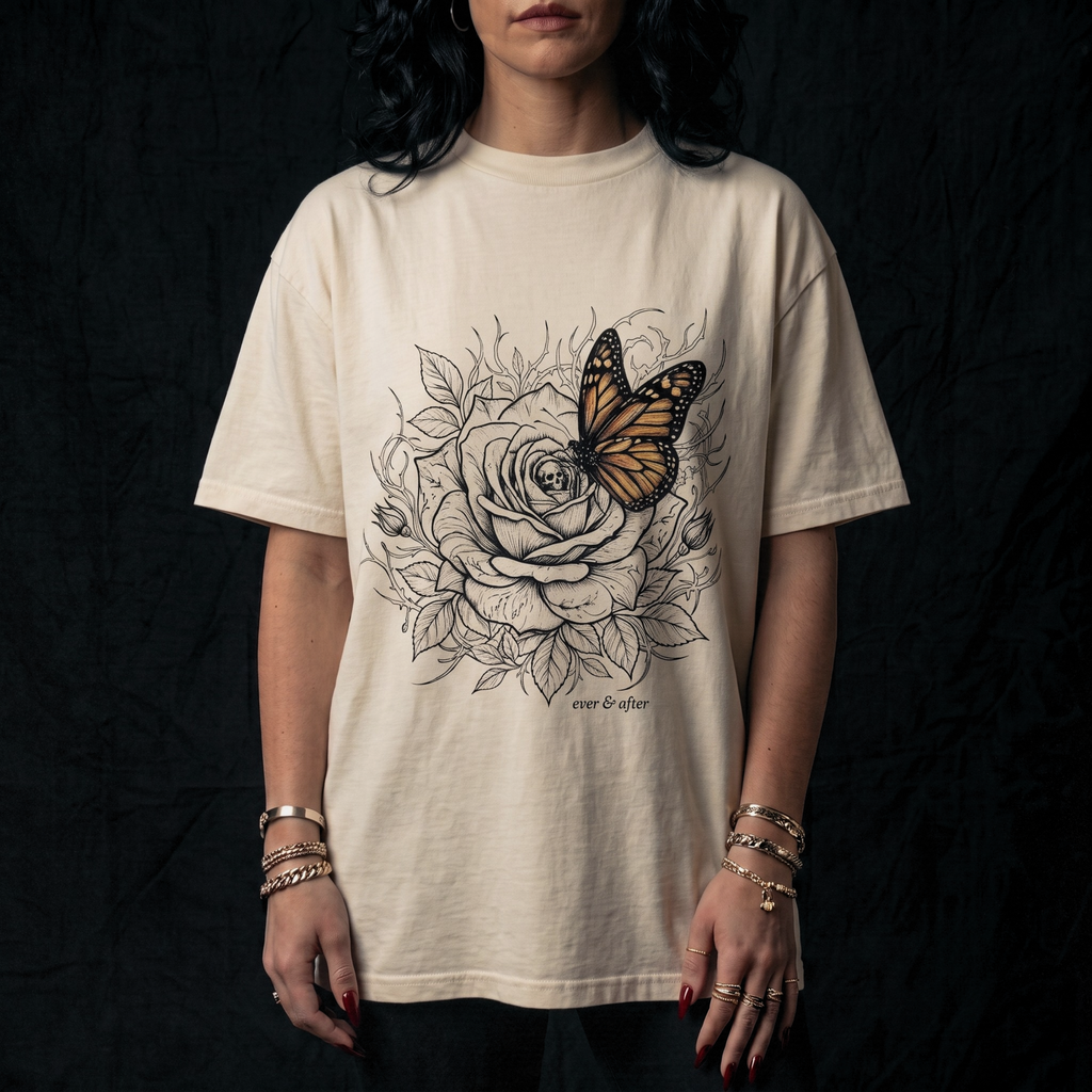 Person wearing a white t-shirt with a butterfly and floral design on a black background