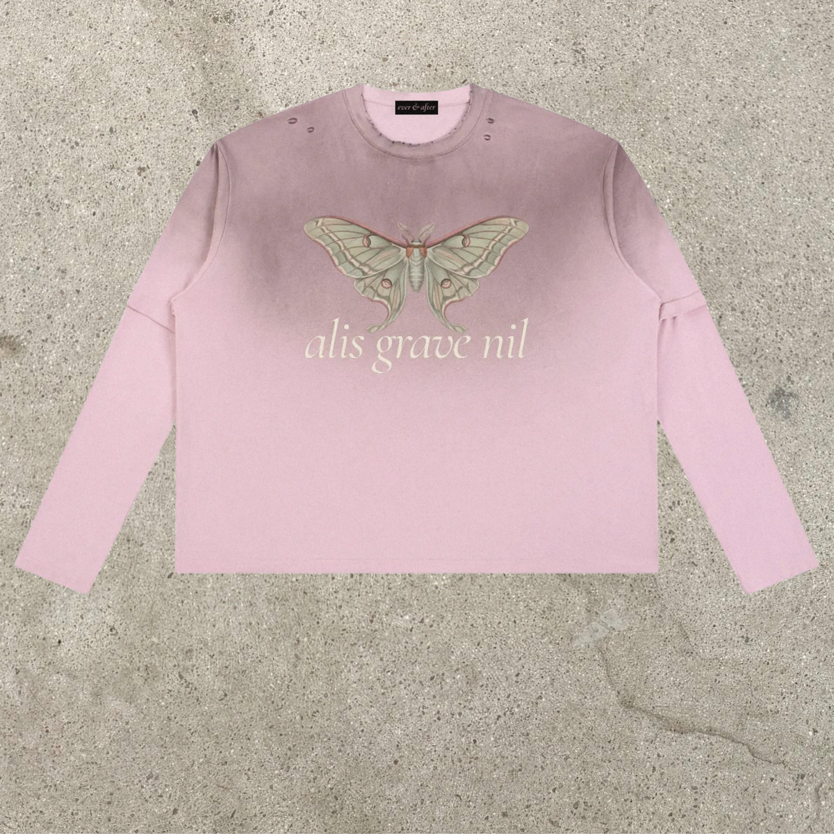 A light pink long-sleeve crewneck sweatshirt featuring a large embroidered moth on the chest and the text 'alis grave nil' embroidered below it, laid flat on a textured concrete surface.