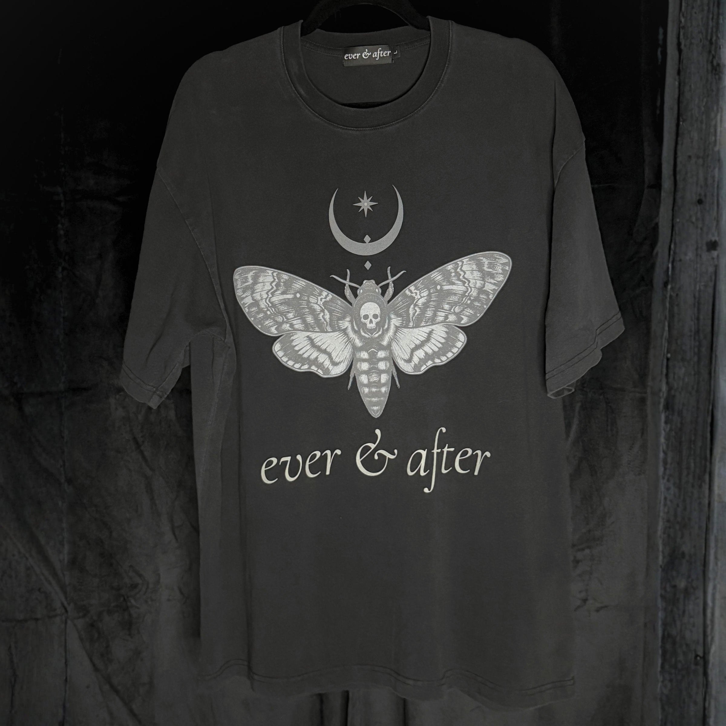 Black t-shirt with a moth design and 'ever & after' text on a dark background