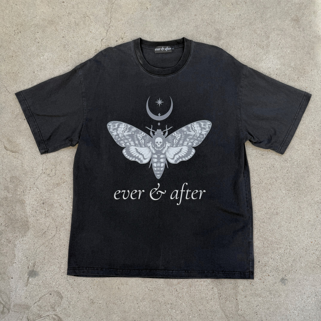 Black t-shirt with a white moth design and 'ever & after' text on a concrete surface