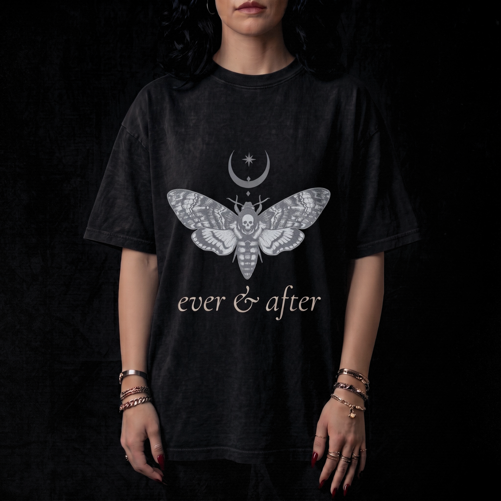 Person wearing a black t-shirt with a moth design and 'ever & after' text on a dark background