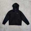 Black hoodie with a brand logo on a concrete floor