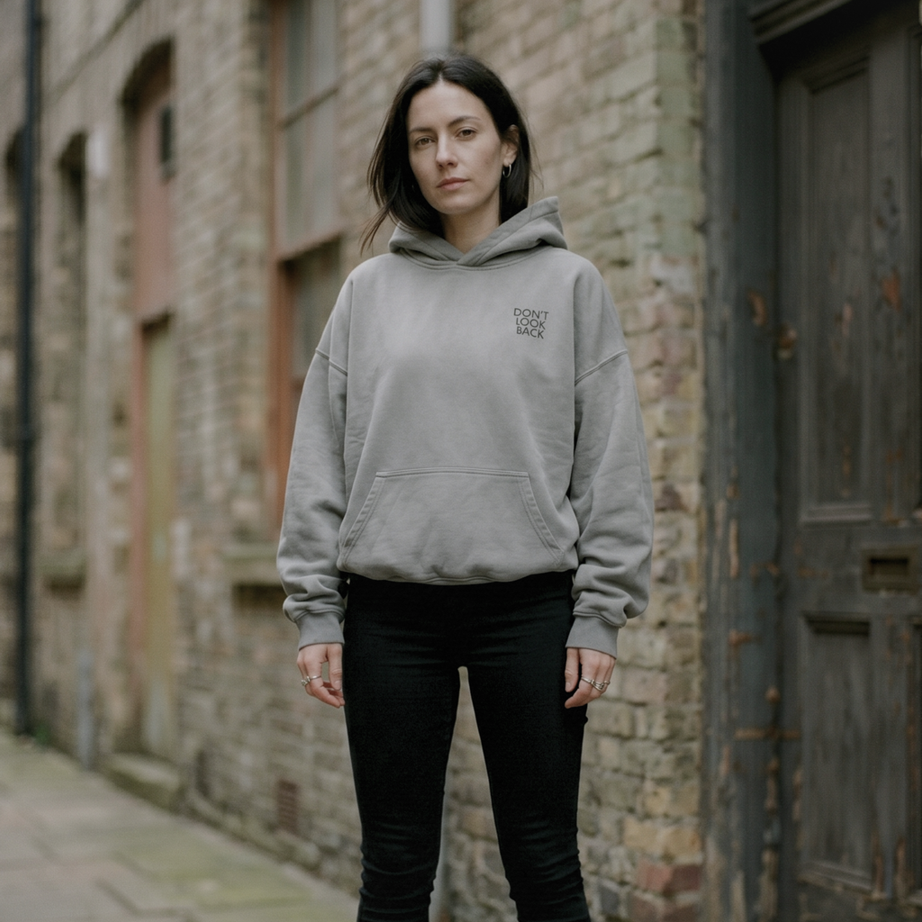 turned to stone oversized hoodie worn by alt millennial woman in alley